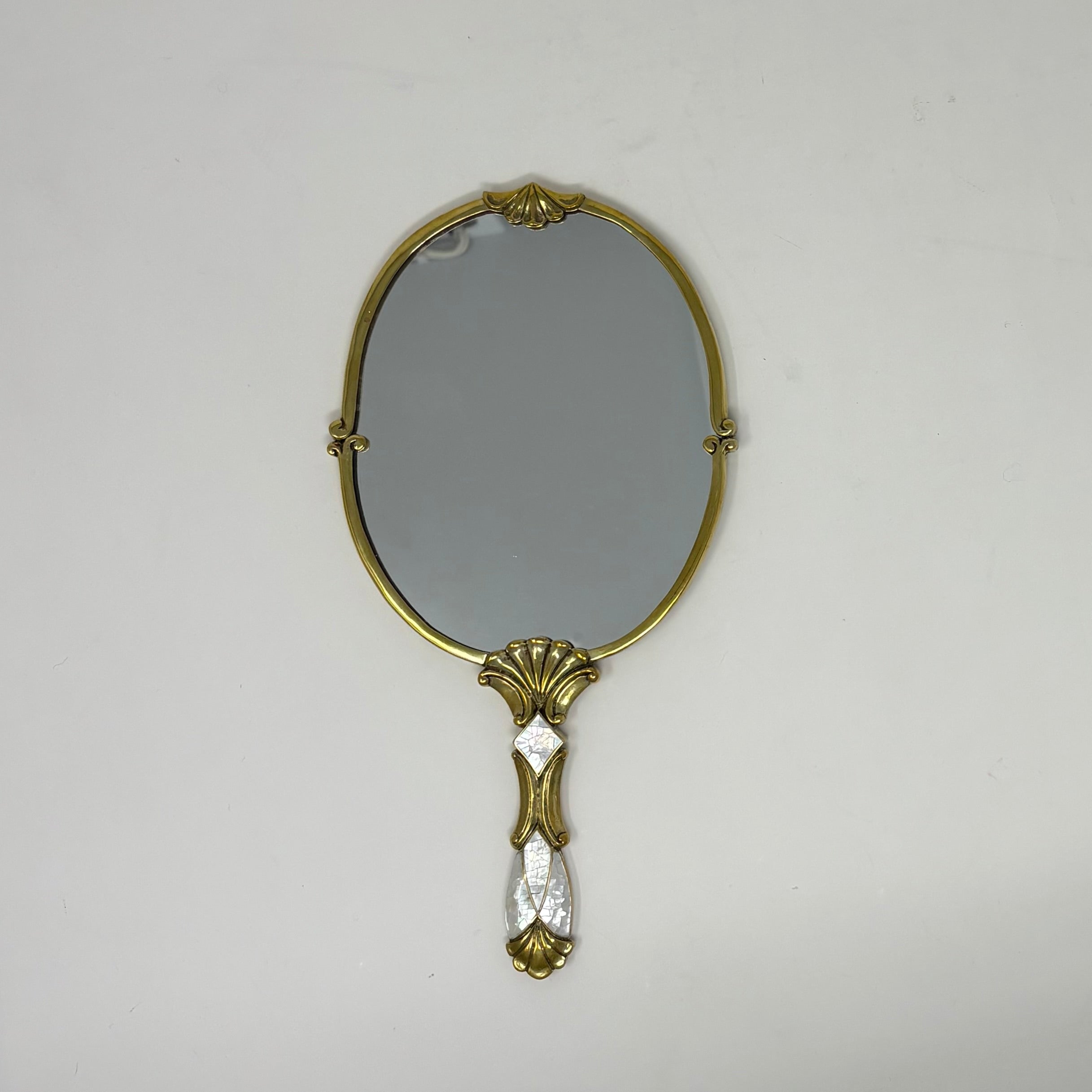 Brass and White Mother of Pearl Inlay Handheld Oval Mirror 4 3/4"w. x 9 1/2" l.