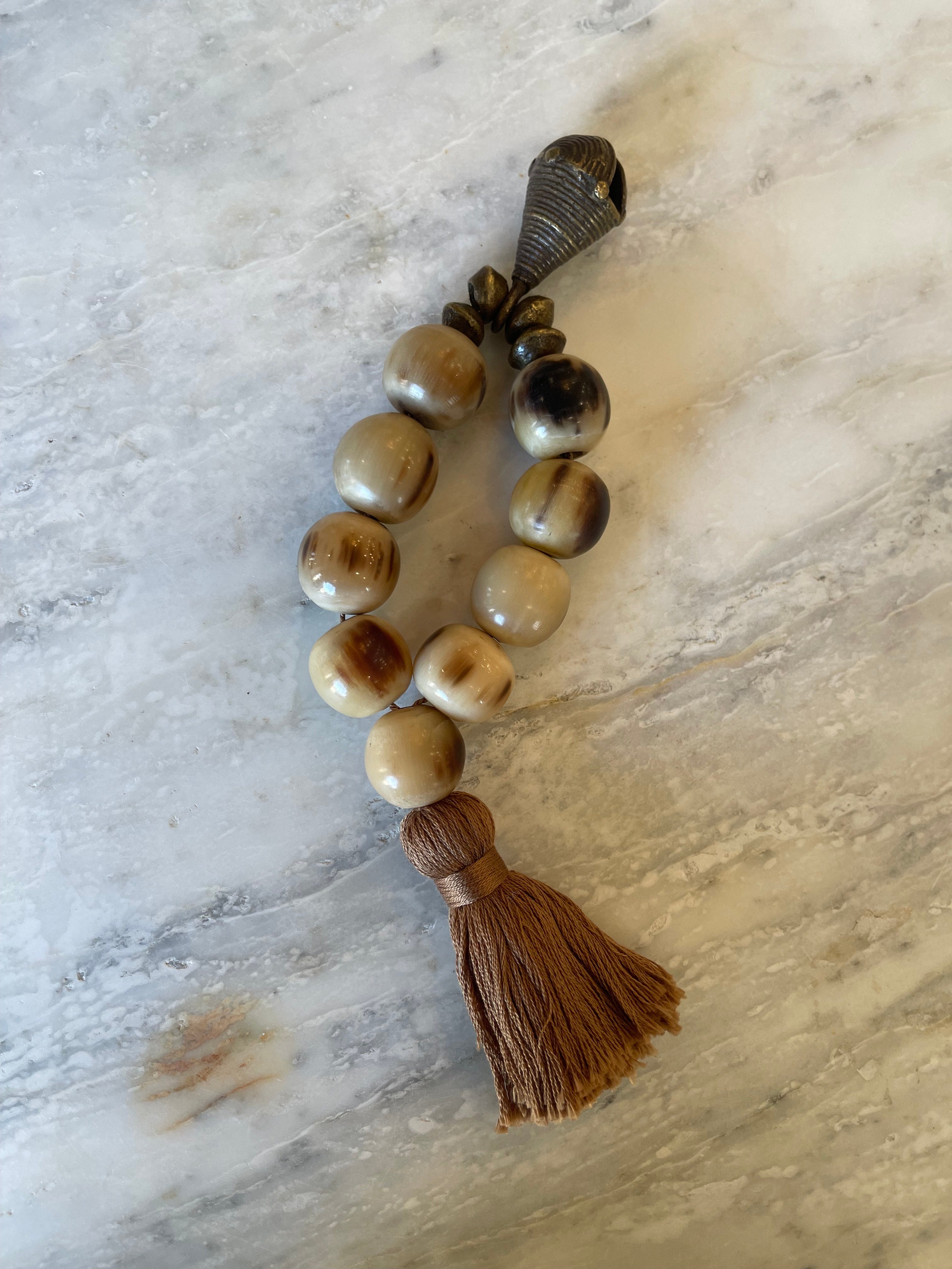 Small Horn Beaded Sculpture with Brown Tassel and Brass Bell